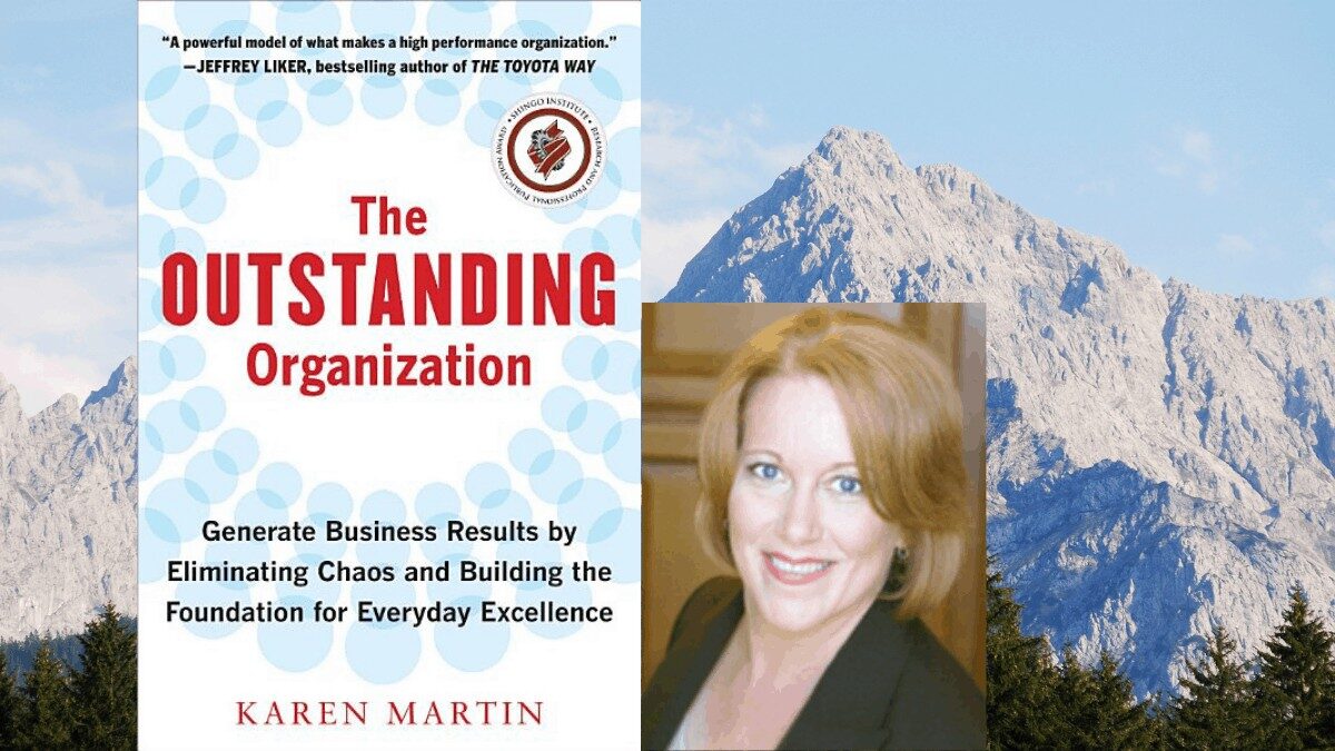 A promotional image for Karen Martin's book "The Outstanding Organization" with a backdrop of mountains, highlighting her expertise in eliminating chaos to generate business results.